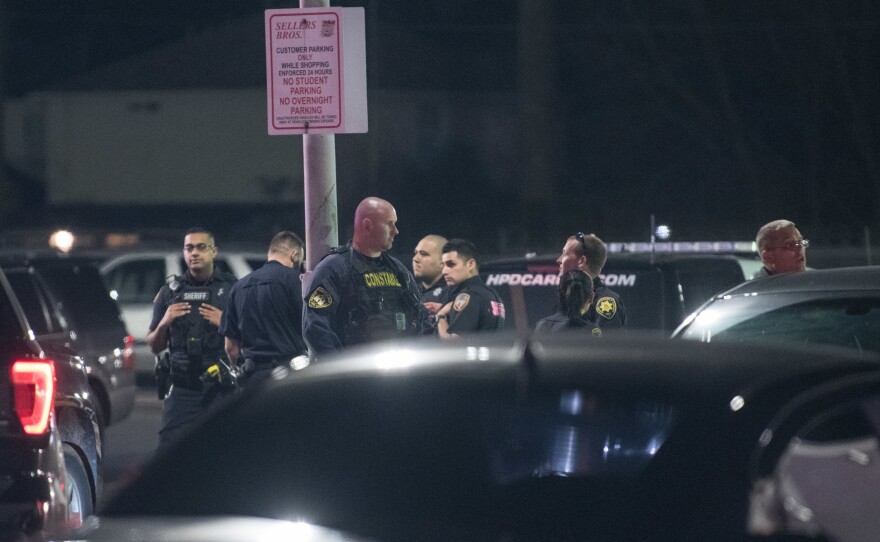 Law enforcement personnel work at the scene of a shooting where four police officers were  shot and a fifth injured after a drug bust in Houston, Texas.
