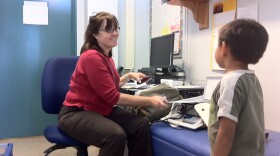 Corinne McCarthy, a San Diego Unified nursing coordinator for schools from Linda Vista to Tierrasanta, prepares to give a Carson Elementary student a hearing screening, Oct. 25, 2012.