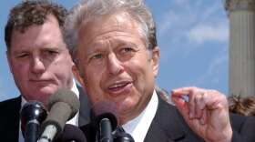 Lawyer Laurence Tribe speaks to reporters outside the Supreme Court in 2003. The Harvard law professor will spearhead a project within the Justice Department to help low-income people receive legal help.