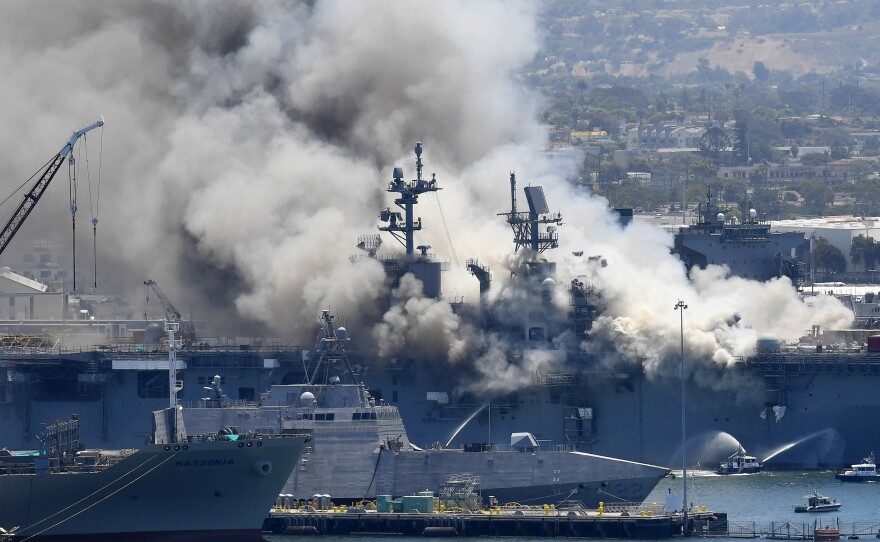 Smoke rises from the USS Bonhomme Richard after an explosion and fire on board the amphibious assault ship at Naval Base San Diego. The Navy is investigating whether the fire was due to arson.