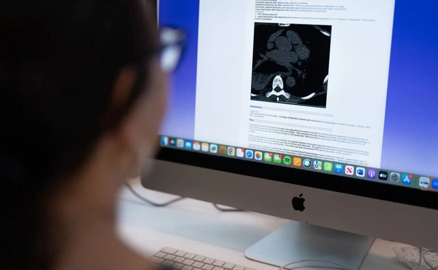 Mary Kuhn looks at a CT scan and explanation of her condition at her home in Lafayette on Oct. 11, 2025. Kuhn had urgent surgery delayed and denied by Blue Shield of California for over half a year before finally getting it approved in June of 2025.