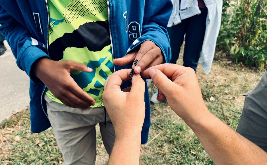 Monarch Watch relies on volunteers to help tag butterflies like this one held by Eli Ivey-Caldwell.