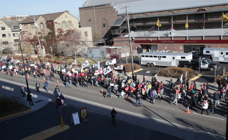 Protestors march outside TCF Bank Stadium before an NFL football game between the Minnesota Vikings and the Washington Redskins, on Sunday in Minneapolis.