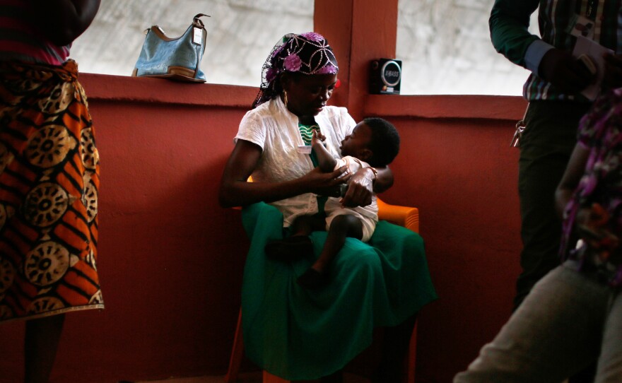 Baby Sekou Dukuly, 3-months-old, is held by a caretaker at a shelter run by ChildFund in Monrovia, Liberia. Later that day, the baby is reunited with his extended family.