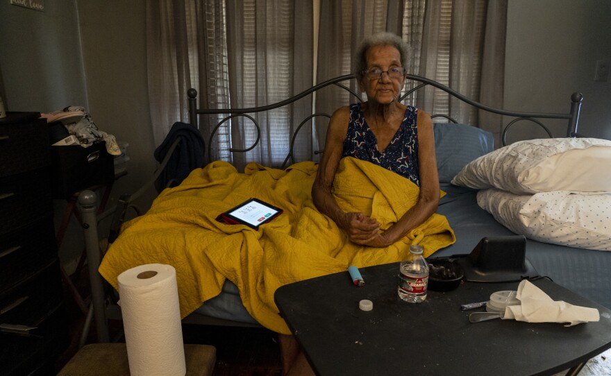 Young sits in her home after receiving a delivery of water bottles provided by the Salvation Army.