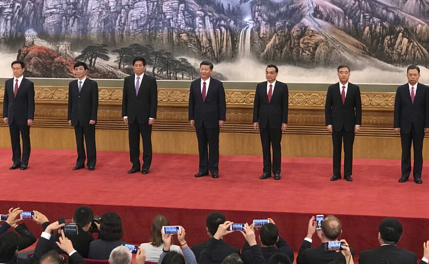New members of the Politburo Standing Committee, from left, Han Zheng, Wang Huning, Li Zhanshu, Xi Jinping, Li Keqiang, Wang Yang, Zhao Leji stand together at Beijing's Great Hall of the People on Wednesday.