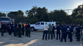 A briefing is being held at the ICP before crews continue to extinguish hot spots on Aug. 18, 2026.