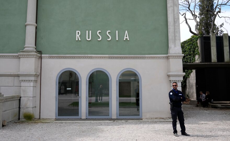 FILE - A private security officer stands next to a closed Russia's pavilion at the 59th Biennale of Arts exhibition in Venice, Italy, Tuesday, April 19, 2022.