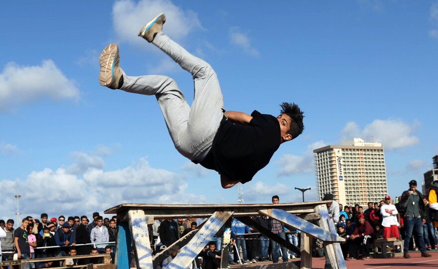 A Libyan youth displays his skills in parkour, an extreme sport, during a friendly competition in Tripoli on March 7, 2014.