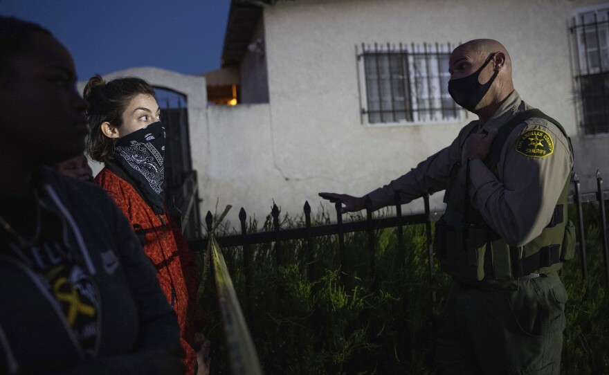 A protester talks with a deputy of the Los Angeles Sheriff's Department during protests following the death of Dijon Kizzee on Monday in Los Angeles.