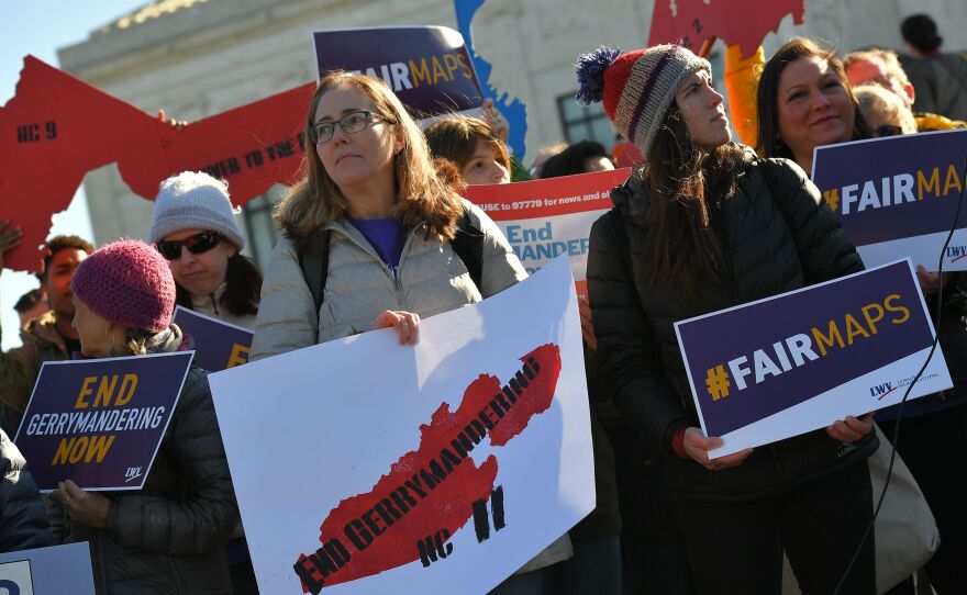People rally in front of the Supreme Court on March 26 as the court hears arguments in redistricting cases. The court ruled that partisan redistricting is a political question, not one that federal courts can weigh in on.
