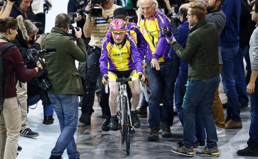 The centenarian was mobbed by members of the media at the velodrome on Wednesday.