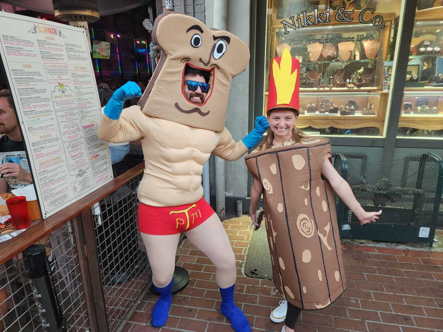 A couple dressed as Powdered Toast Man and LOG from the cartoon series Ren & Stimpy strike a pose on Fifth St. in the Gaslamp Quarter on July 26, 2025.