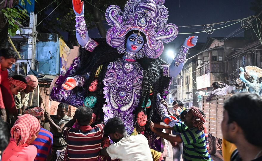 Laborers transport an idol of the Hindu goddess Kali to a place of worship on the eve of Diwali at Kumortuli, the traditional potters' quarter in northern Kolkata on Wednesday.