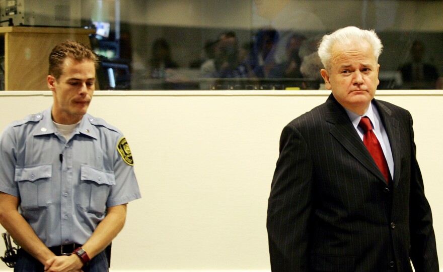 Former Yugoslav President Slobodan Milosevic enters the courtroom at the U.N. war crimes tribunal in the Hague, the Netherlands, in 2004. Despite strong political support from Russia, Milosevic was ousted and put on trial for genocide. He died in 2006 in his prison cell while the trial was ongoing.