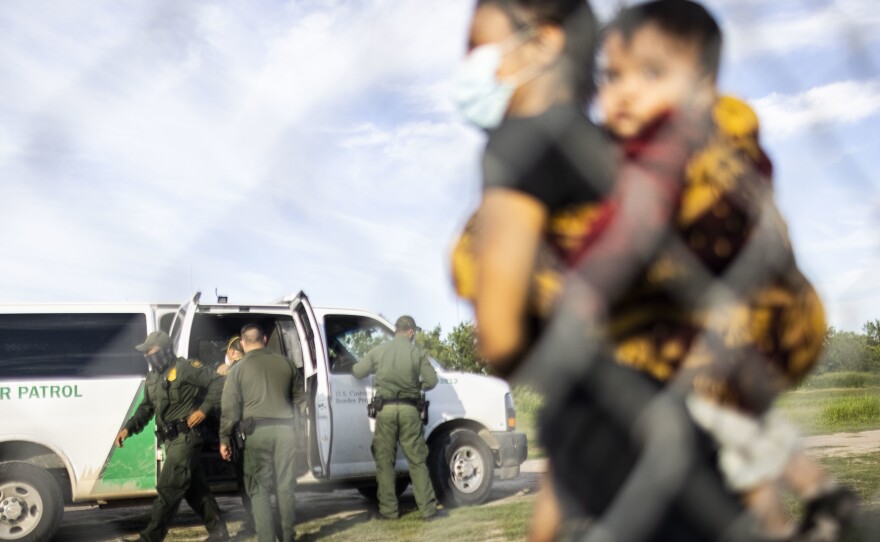 Migrants are apprehended by U.S. Customs and Border Protection (CBP) agents after crossing the Rio Grande in LaJoya, Texas on June 12. Benioff kept Salesforce's contract with the CBP despite opposition from his own employees.