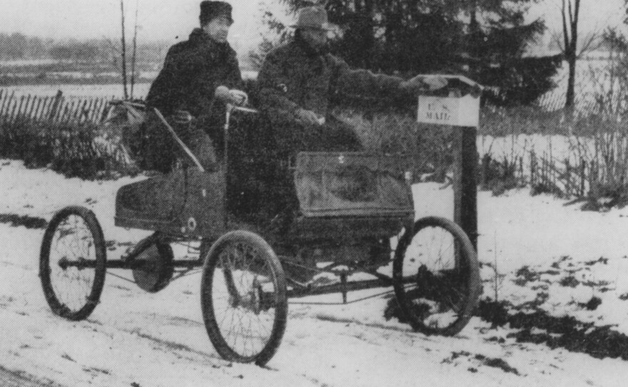 A rural mail carrier in 1905 trying out new transportation technology.