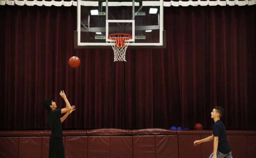 Angel plays basketball before starting the school day in Minto.