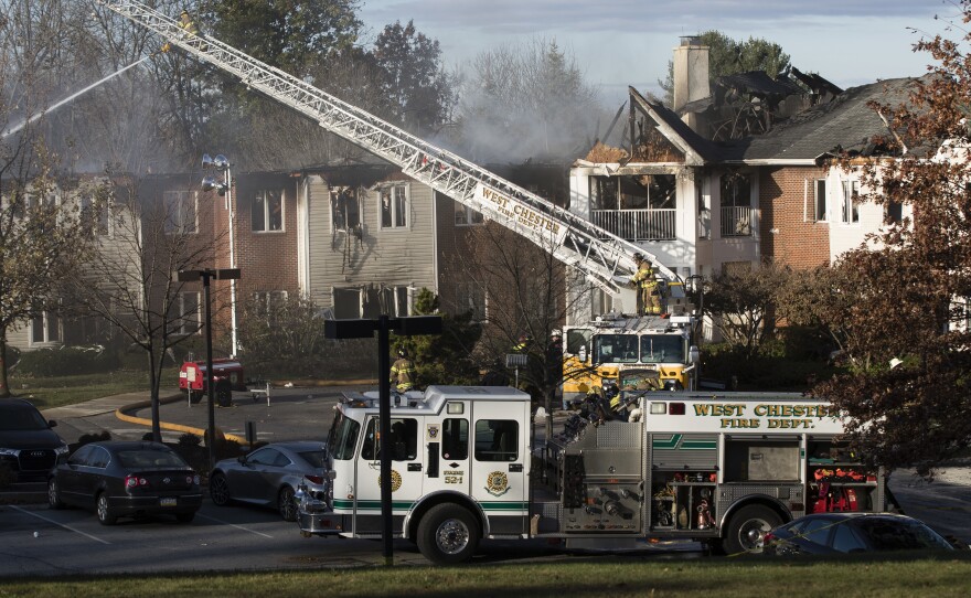Firefighters worked on Friday to put out the smoldering fire that blazed across the rooftops of the Barclay Friends Senior Living Community in West Chester, Pa., the previous night.