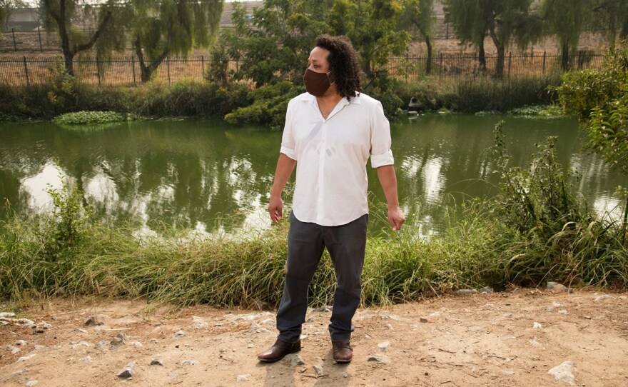 Nicholas Hatten, an environmental justice advocate, poses for a portrait near the slough behind his apartment in Stockton, Calif. on September 13, 2020. Hatten is a Black LGBT advocate who lives near harmful algal bloom.