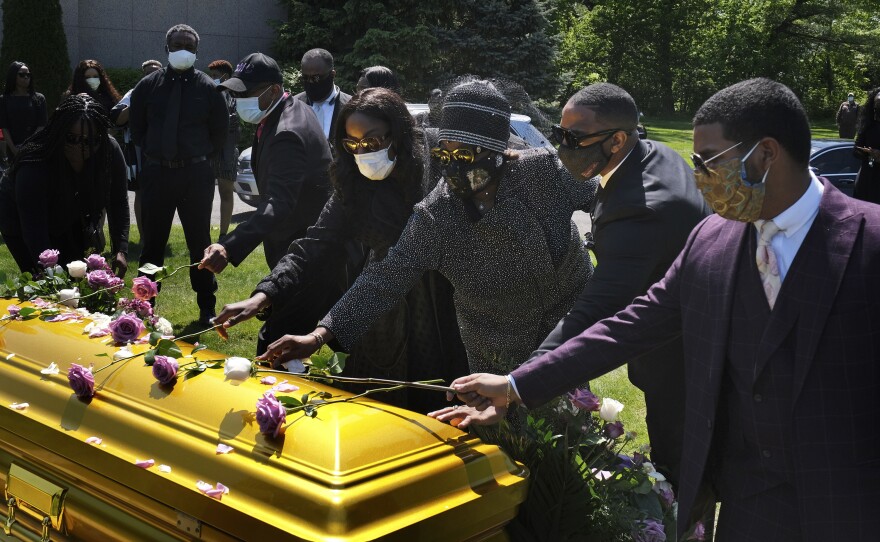 Family and friends lay flowers on the casket of Bishop Carl Williams Jr. last week at Hollywood Memorial Park and Cemetery in Union, N.J. Only a few family members were permitted to attend the service in person due to the pandemic.