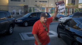 Rene Zambrano, a teacher at Lincoln High School and member of the San Diego immigrant advocacy group Unión del Barrio, hands out fliers outside the campus on Tuesday, Aug. 19, 2025.