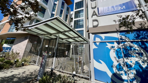 The CSUSM cougar logo is seen under signage for "The Quad" student housing, Oct. 9, 2026.
