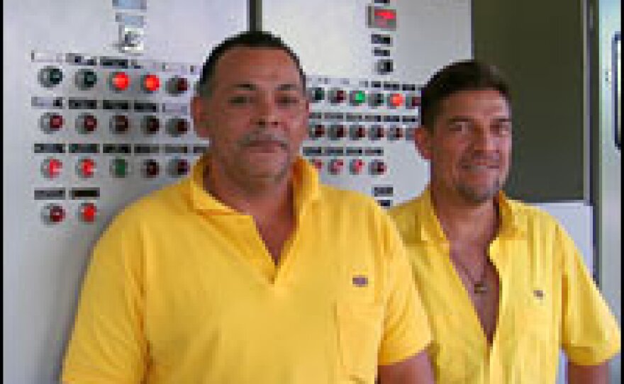 Technicians at the Angostura plant monitor water levels and electrical output.