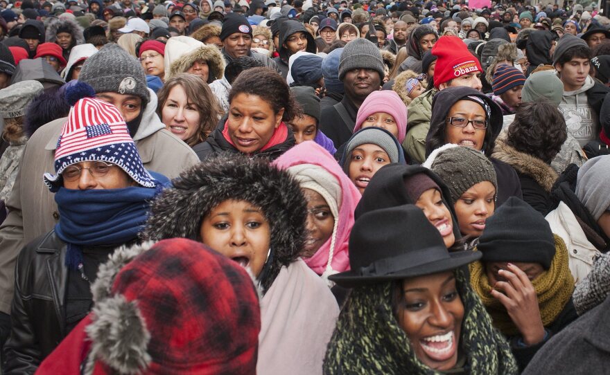 A crowd walks through downtown Washington, D.C., toward the National Mall.