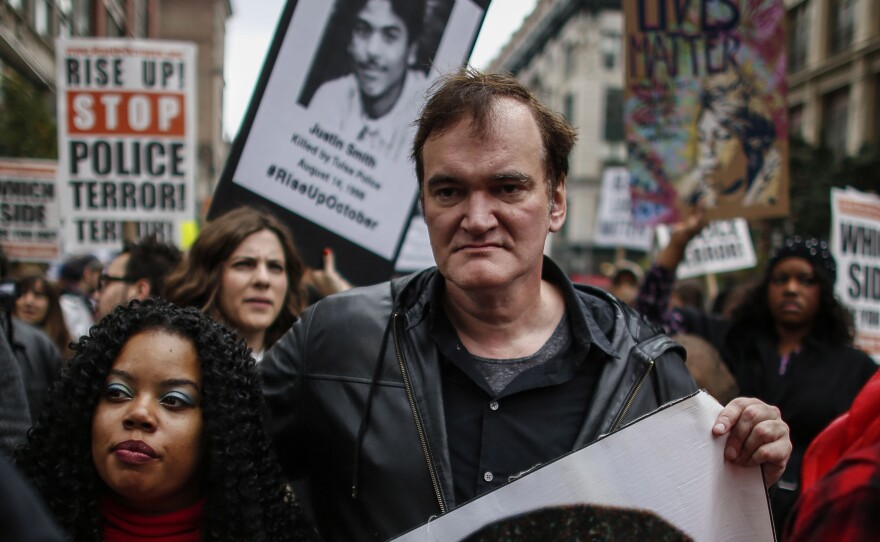 Director Quentin Tarantino attends a march to denounce police brutality in New York City on Oct. 24. At the rally, Tarantino said, "I have to call the murdered the murdered, and I have to call the murderers the murderers" — drawing considerable backlash from police unions.