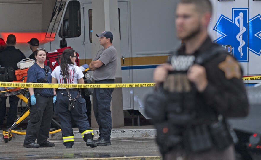 Emergency personnel gather after a deadly shooting Sunday, July 17, 2022, at the Greenwood Park Mall, in Greenwood, Ind.