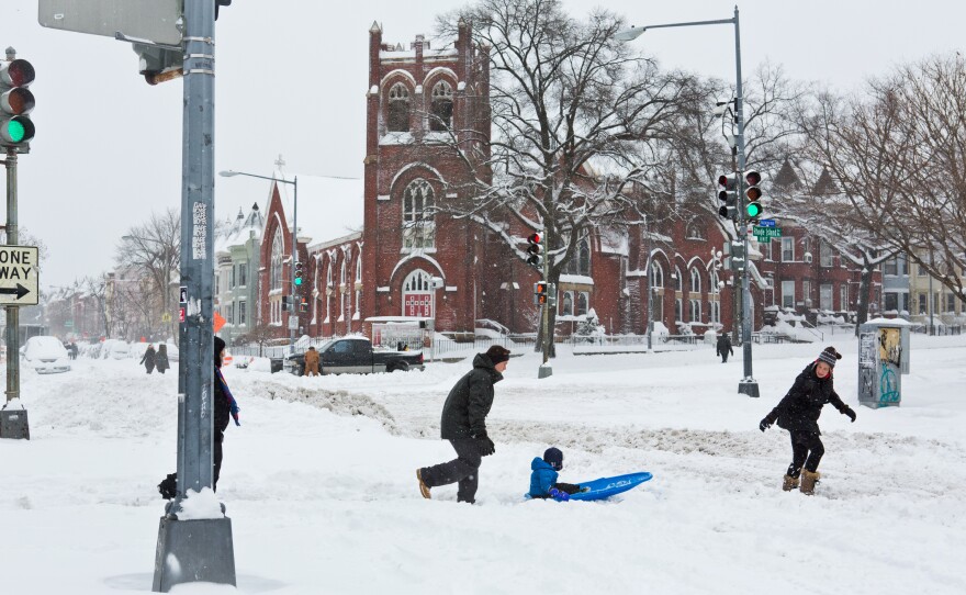 Residents take advantage of a break in the snow to wander down Rhode Island Avenue in Washington, D.C.