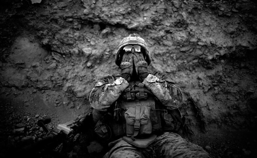 Marine Lance Cpl. Anthony Espinoza wipes the sweat out of his eyes at the end of a daylong patrol out of the Sangin District in southern Afghanistan in 2011.