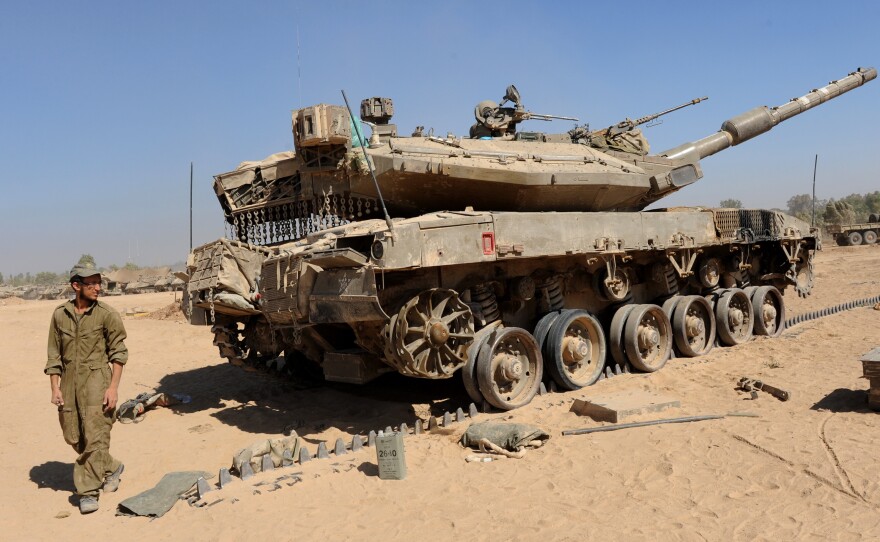 An Israeli Merkava tank near the Hamas-controlled Gaza Strip border in southern Israel, on Thursday. The Pentagon confirms that Israel tapped a U.S. weapons stockpile for tank rounds.