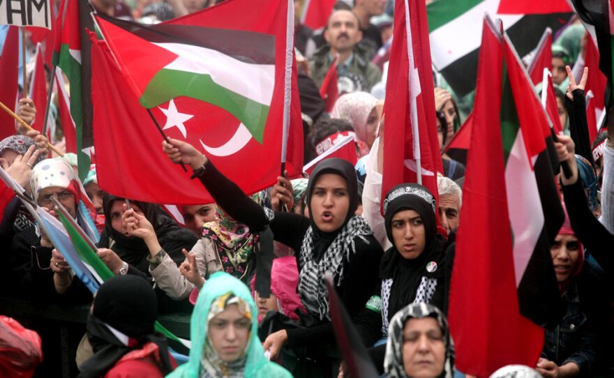 Pro-Palestinian demonstrators wave Turkish and Palestinian flags during a protest Sunday in Ankara against Israel's deadly raid on a Gaza-bound aid ship. The attack was the latest blow to U.S.-Turkish relations.