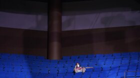 A President Donald Trump supporter sits in the stands wearing a face mask during a campaign rally at the BOK Center, Saturday, June 20, 2020, in Tulsa, Okla. 