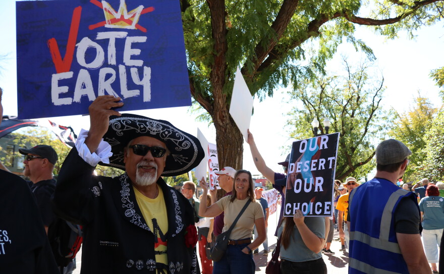 Paul Hinojosa holds a "Vote Early" sign at a No Kings rally in Ogden, Utah, about 40 miles north of Salt Lake City, on Oct. 17.
