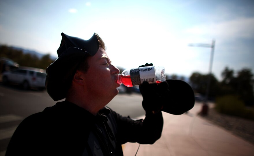 Jonathan Rice, dressed as Darth Vader, gulps down a bottle of Vitamin Water after running a 6:36 mile in the hottest stretch of Death Valley. Rice has been doing the run to try and set a world record for the fastest mile run in a record-setting temperature and has dubbed it the "Darth Valley Challenge."