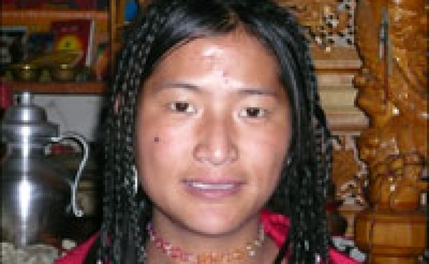 Tibu Zhuoma, 18, says she worries the glacier's retreat could plunge the village back into poverty.