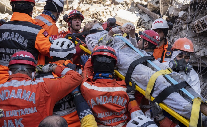 Huseyin Seferoglu, 23, is pulled from the rubble of a collapsed building in Antakya, Turkey, on Sunday.