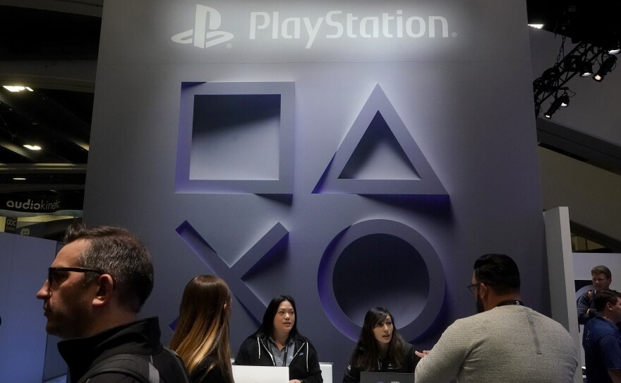 Attendees visit the PlayStation booth at the Game Developers Conference 2023 in San Francisco, Wednesday, March 22, 2023.