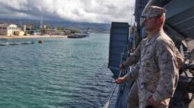 Marines from the 15th Marine Expeditionary Unit watch as the USS Rushmore leaves U.S. Naval Base Pearl Harbor, Hawaii, a week into the unit's Western Pacific Deployment, Sept. 25. The MEU and Peleliu Amphibious Ready Group will continue their deployment, where they plan to conduct theater security cooperation exercises and humanitarian operations.