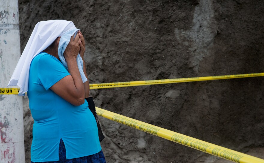 Marcela's grandmother cries at the scene of her granddaughter's death.