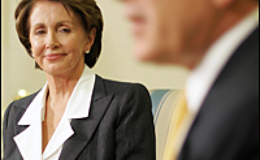 President George W. Bush (foreground) speaks to the press as he is joined by new Democratic U.S. House of Representatives leader Nancy Pelosi Nov. 9, 2006, in the Oval Office of the White House.