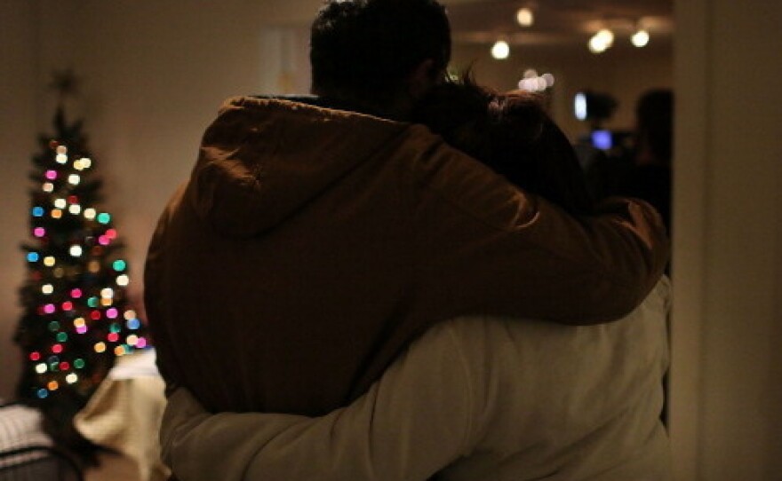 Hanging on to each other: Two people at one of the prayer services Friday night in Newtown, Conn.