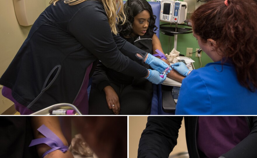 In 2019, as part of a clinical trial to treat sickle cell disease, Gray had vials of blood drawn by nurses Bonnie Carroll (left) and Kayla Jordan at TriStar Centennial Medical Center in Nashville.