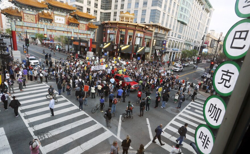 Protesters against police violence stop traffic at a major intersection Wednesday in Washington's Chinatown neighborhood as they begin a march towards the White House.