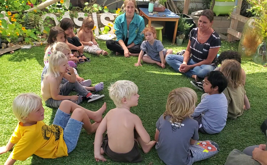 Children sit in a circle at Liberty Winn's home childcare center in Carlsbad, May 18, 2022.