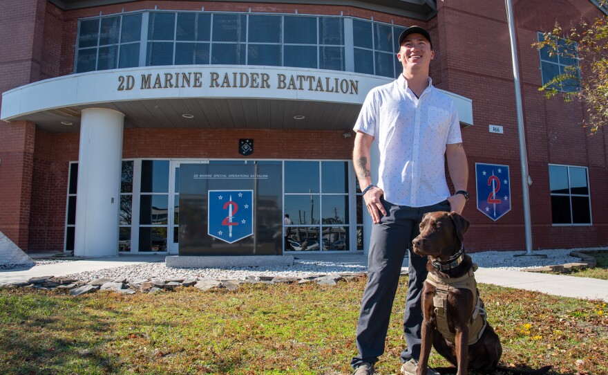 Nick Jones at Marine Corps Base Camp Lejeune in Jacksonville, N.C., on Nov. 8 with his dog Fletcher. This Veterans Day will be Nick's first day as a civilian upon leaving the Marine Corps.