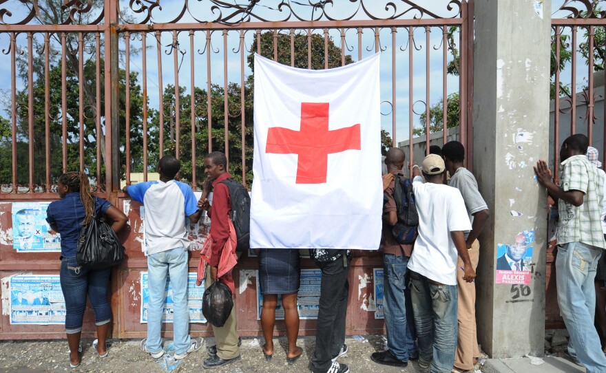 Haitians outside a Red Cross field hospital in Carrefour, Haiti, on Dec. 14, 2010, 11 months after a magnitude 7.0 earthquake hit the country's capital, Port-au-Prince.